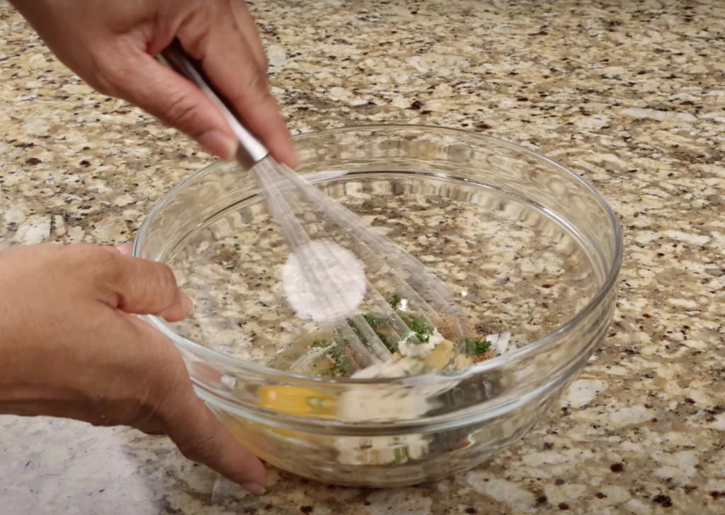 mixing the eggs for Maryland crab cakes